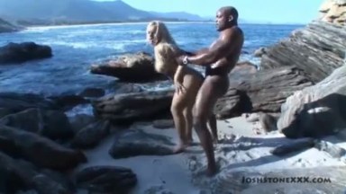 A rich interracial on the seashore